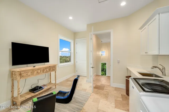 a living room with furniture and a large window