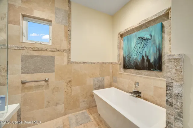 a view of a house with a yard and a large tree