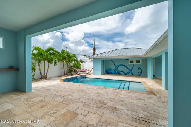 a room with pool table and a potted plant