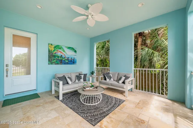a living room with furniture and a floor to ceiling window