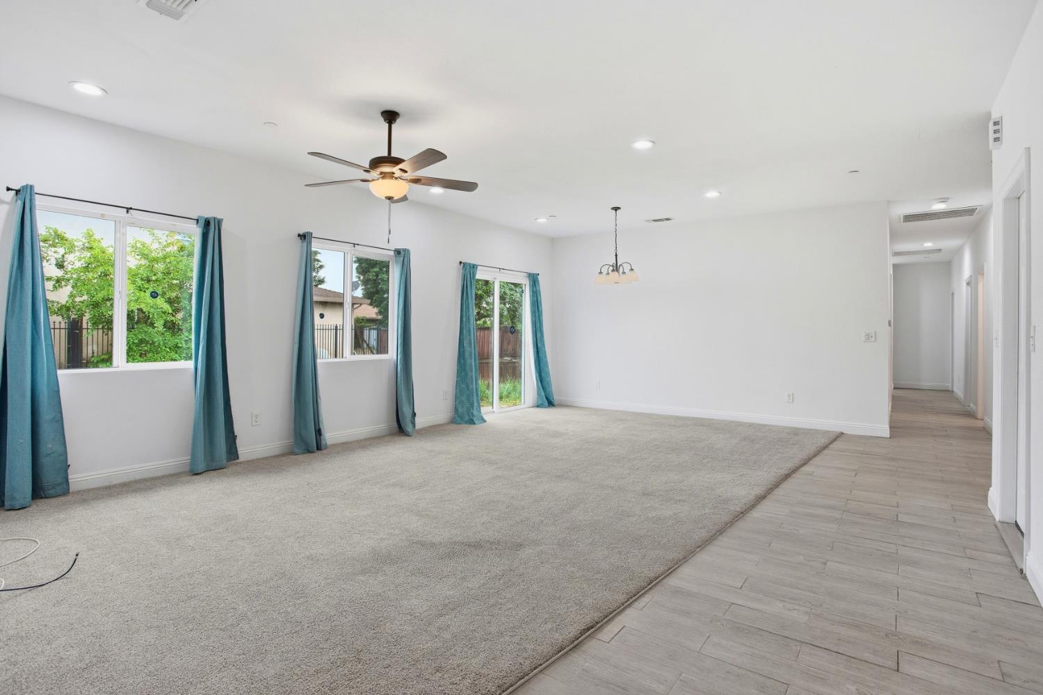 5680 Power Inn Road Sacramento, CA 95824 - Photo 5 of 48 a view of a big room with windows and chandelier fan
