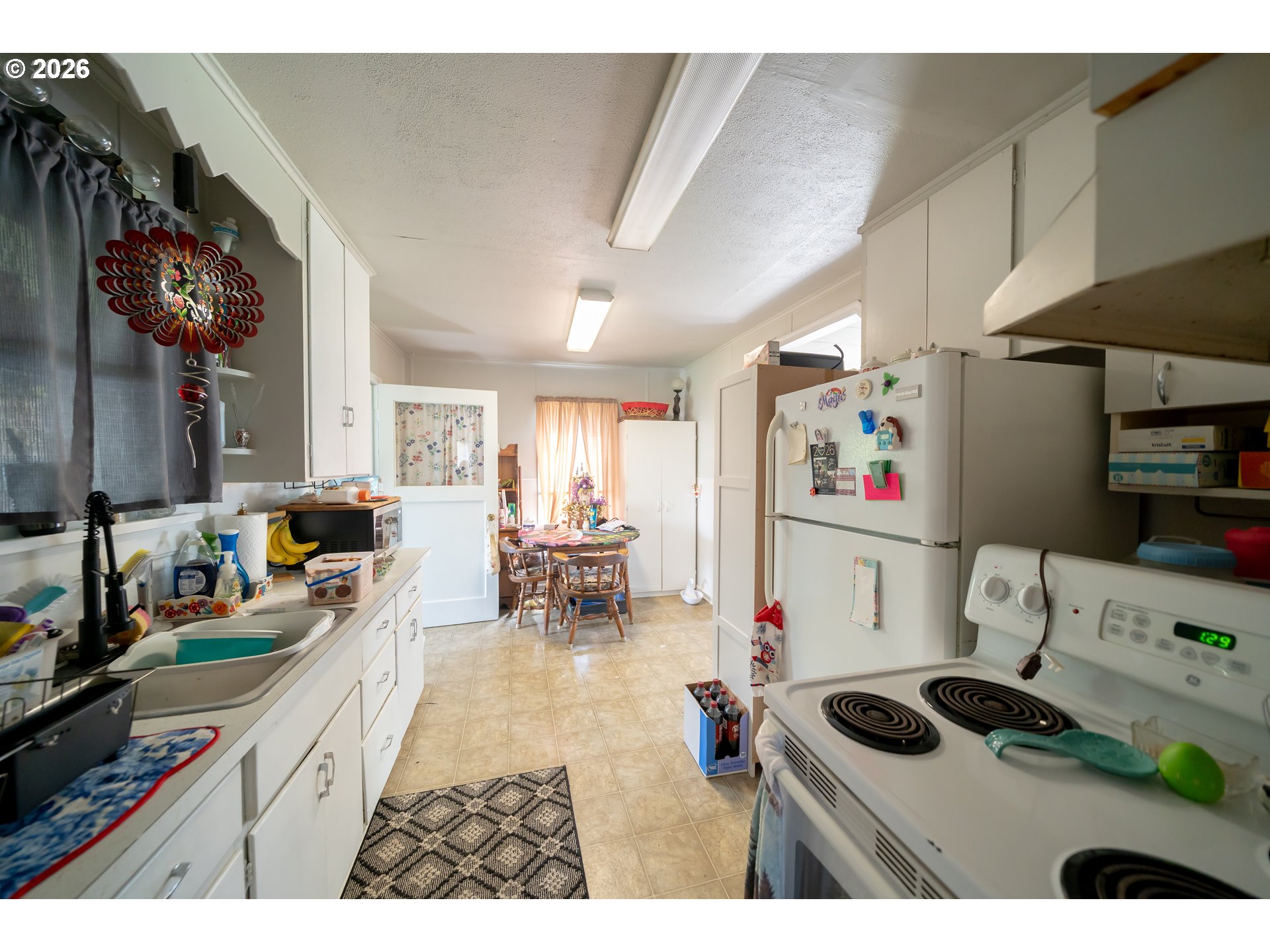 1450 Southwest 9th Street Dallas, OR 97338 - Photo 5 of 15 a kitchen filled with a stove a refrigerator and a fireplace