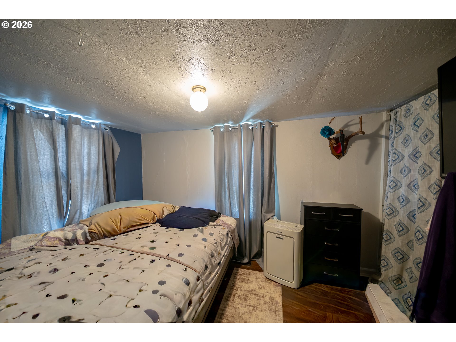 1450 Southwest 9th Street Dallas, OR 97338 - Photo 6 of 15 a bedroom with a bed and a walk in closet