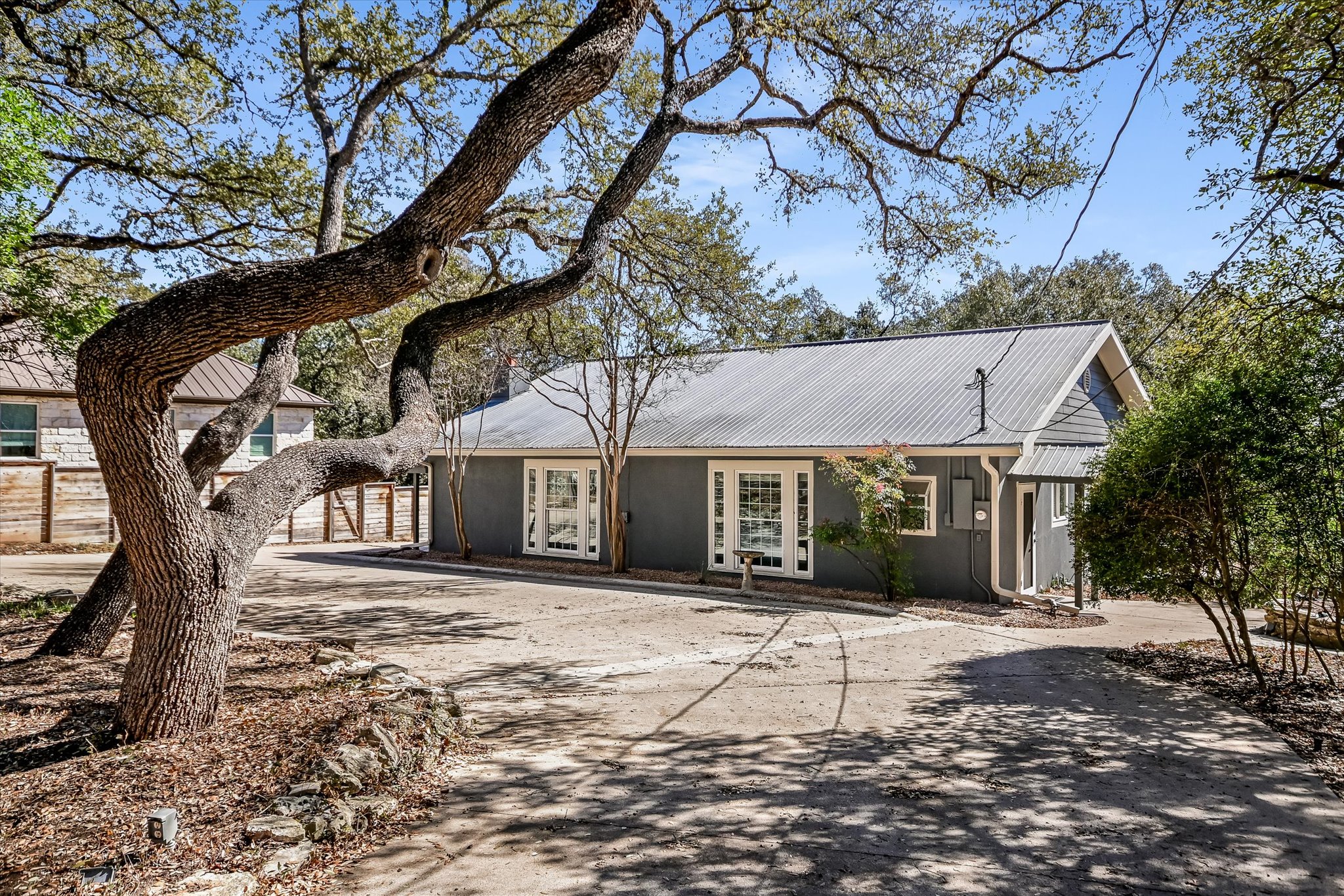 6111 Hudson Bend Road Austin, TX 78734 - Photo 31 of 40 View of front of home with concrete driveway and a metal roof