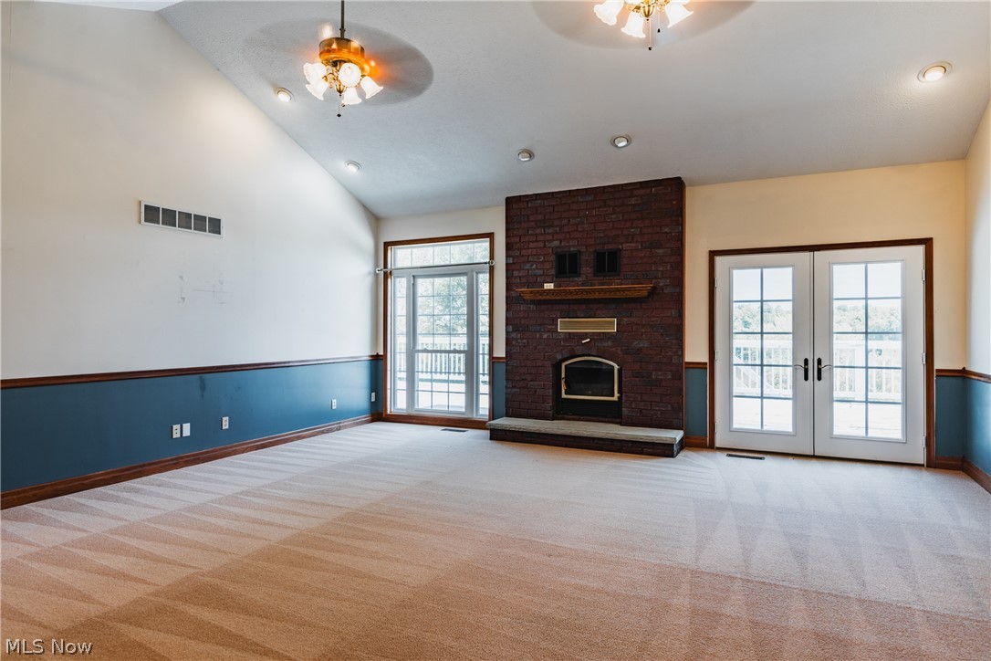 124 Riverview Acres Road Washington, WV 26181 - Photo 7 of 46 Great room fireplace wall with floor to ceiling window and patio door to back deck