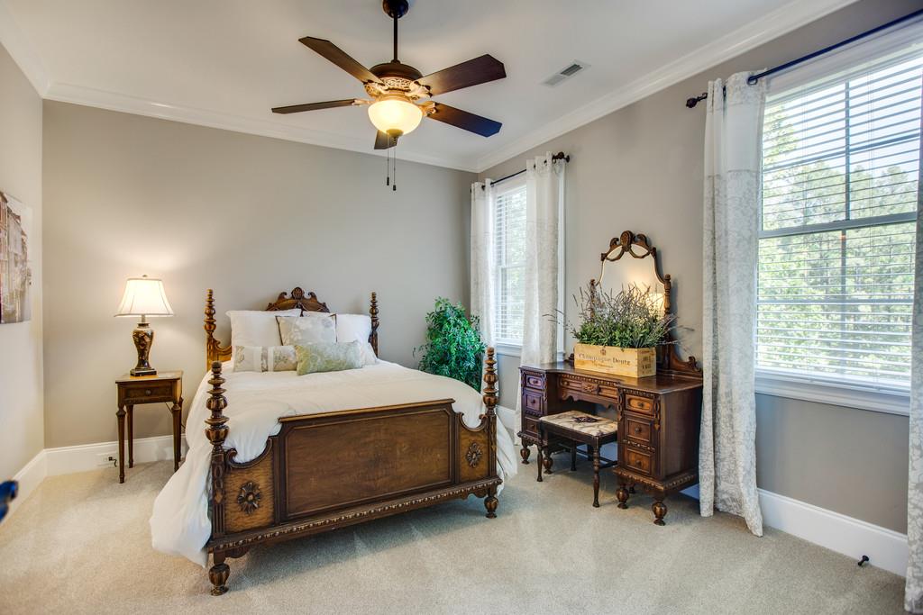 5939 Greenbriar Road Franklin, TN 37064 - Photo 17 of 30 a bedroom with a bed and a chandelier