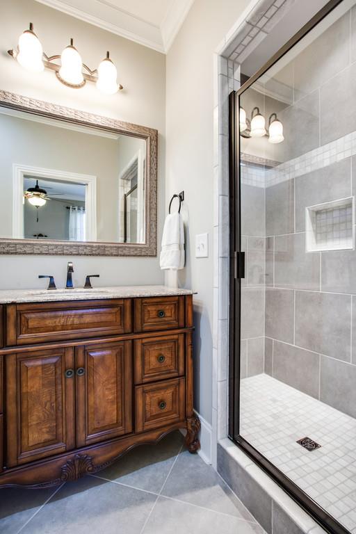 5939 Greenbriar Road Franklin, TN 37064 - Photo 18 of 30 a bathroom with a sink a vanity and shower