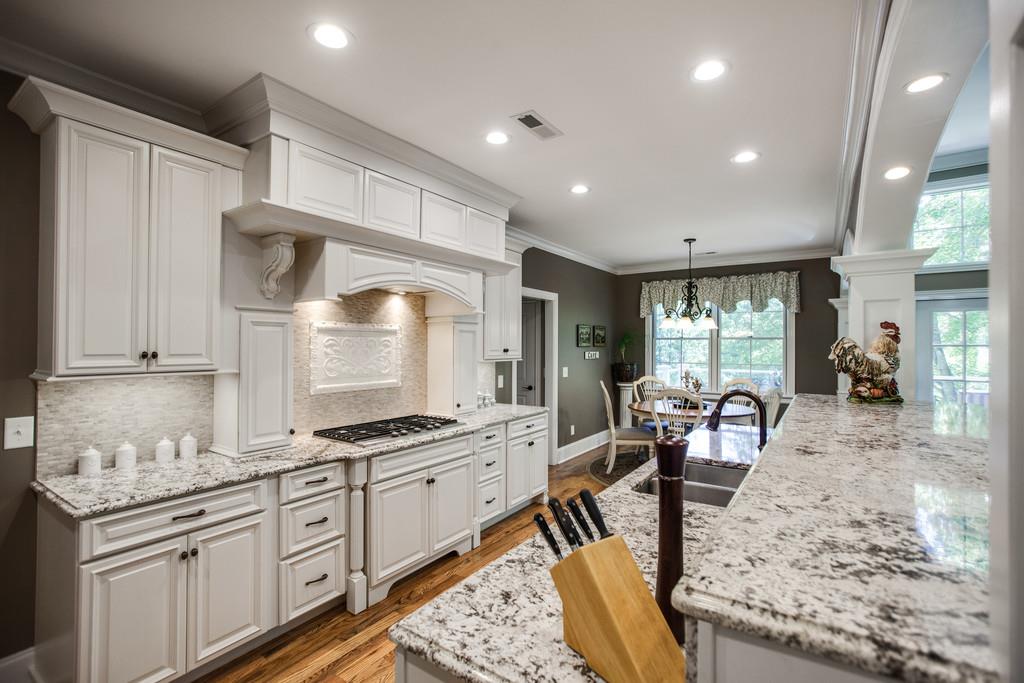 5939 Greenbriar Road Franklin, TN 37064 - Photo 8 of 30 a kitchen with granite countertop sink stove and cabinets