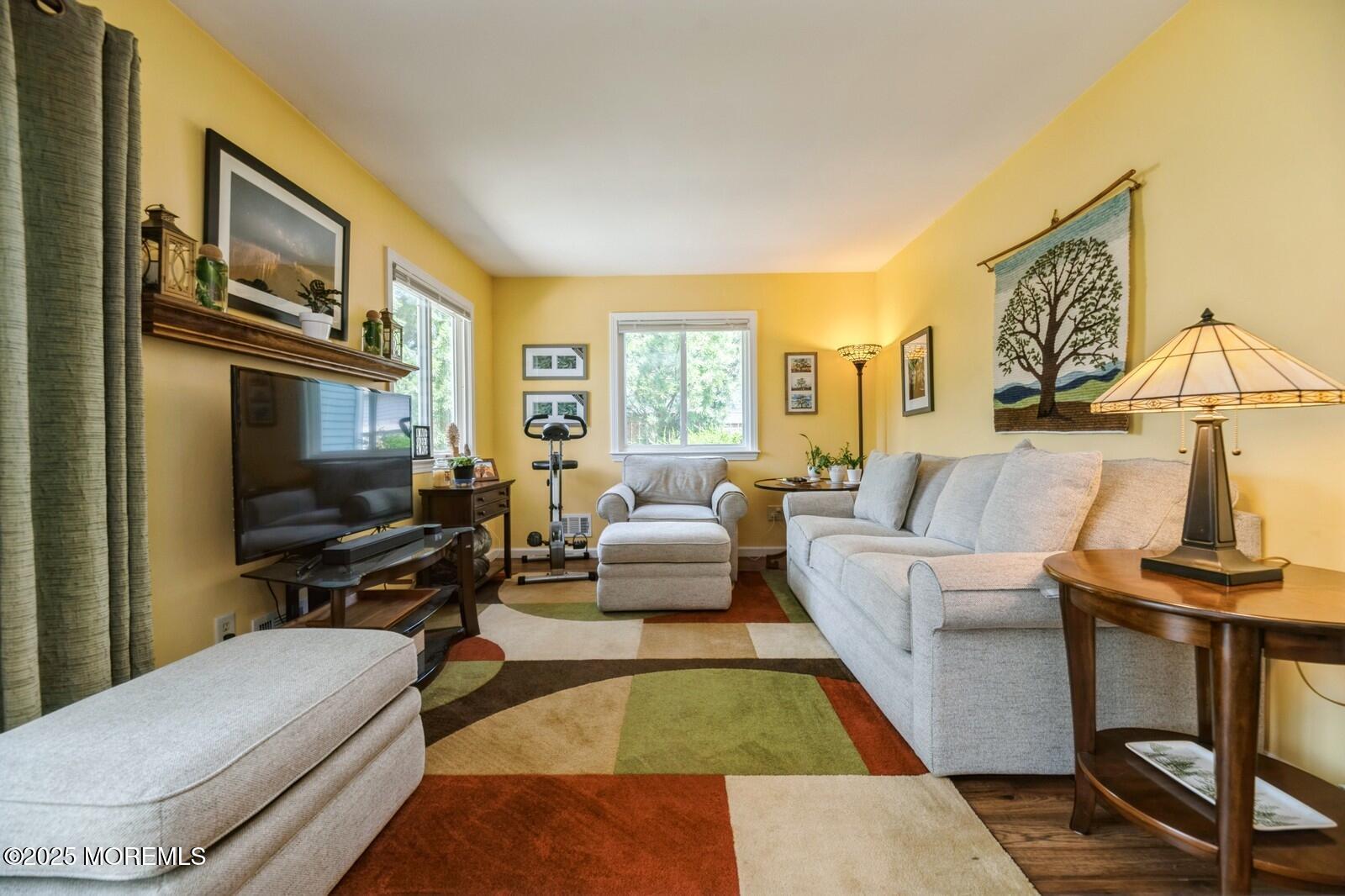 60 Appletree Road Howell, NJ 07731 - Photo 11 of 28 a living room with furniture fireplace and a flat screen tv
