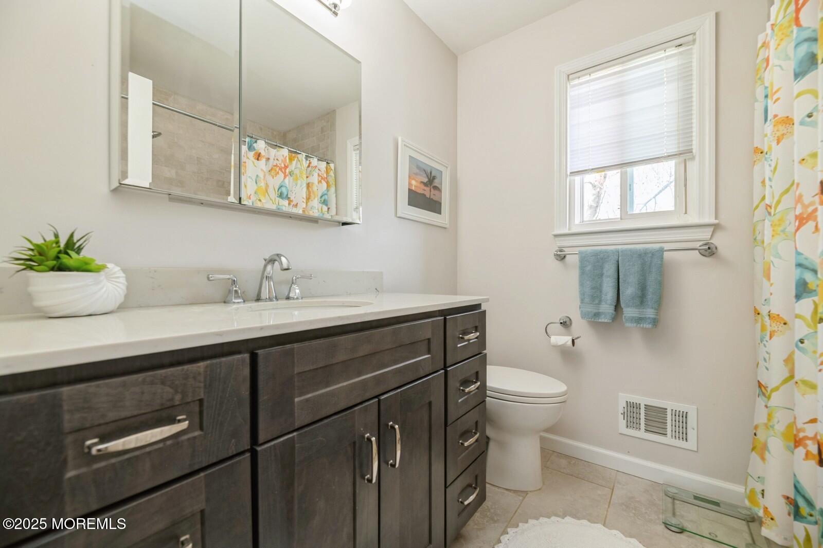 60 Appletree Road Howell, NJ 07731 - Photo 18 of 28 a bathroom with a granite countertop toilet sink and mirror