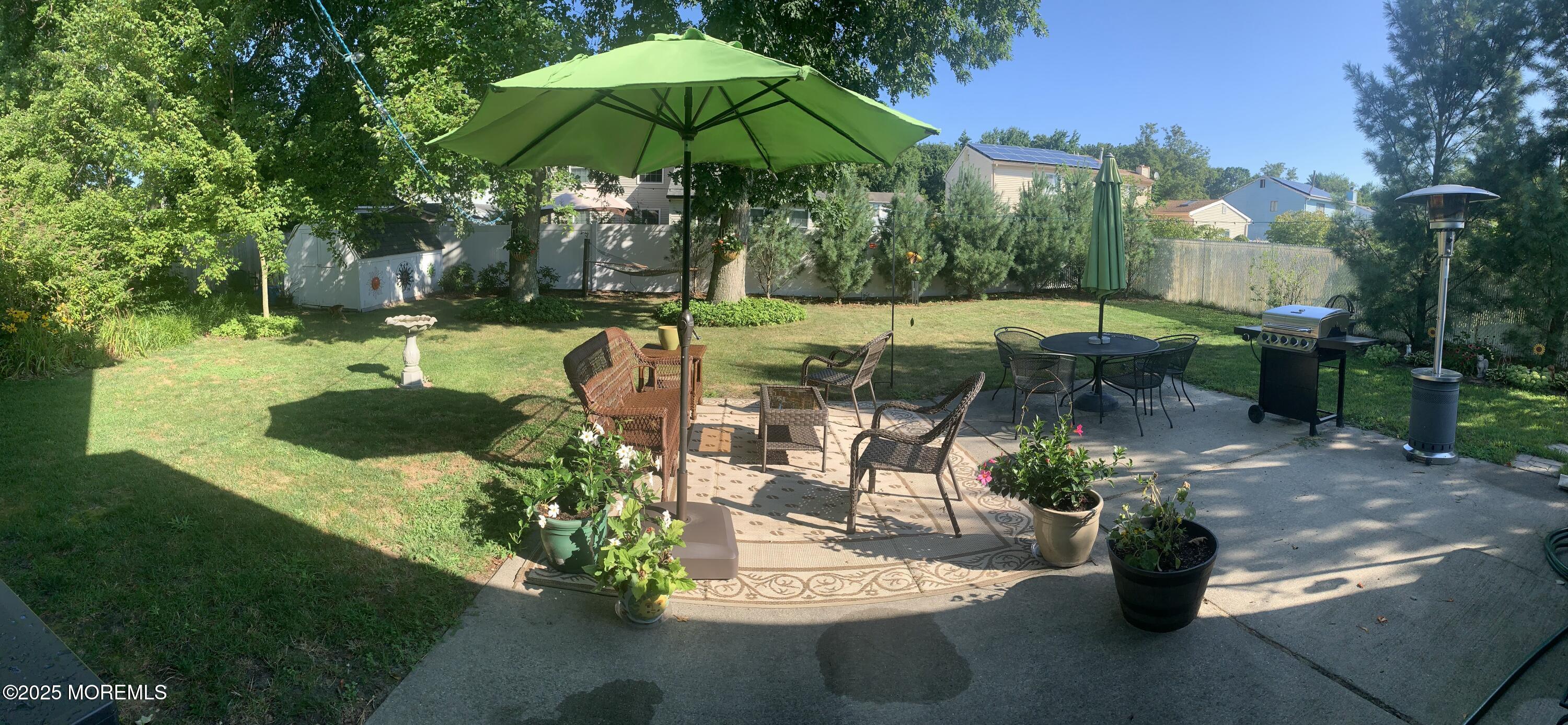 60 Appletree Road Howell, NJ 07731 - Photo 21 of 28 a view of a table and chairs under an umbrella