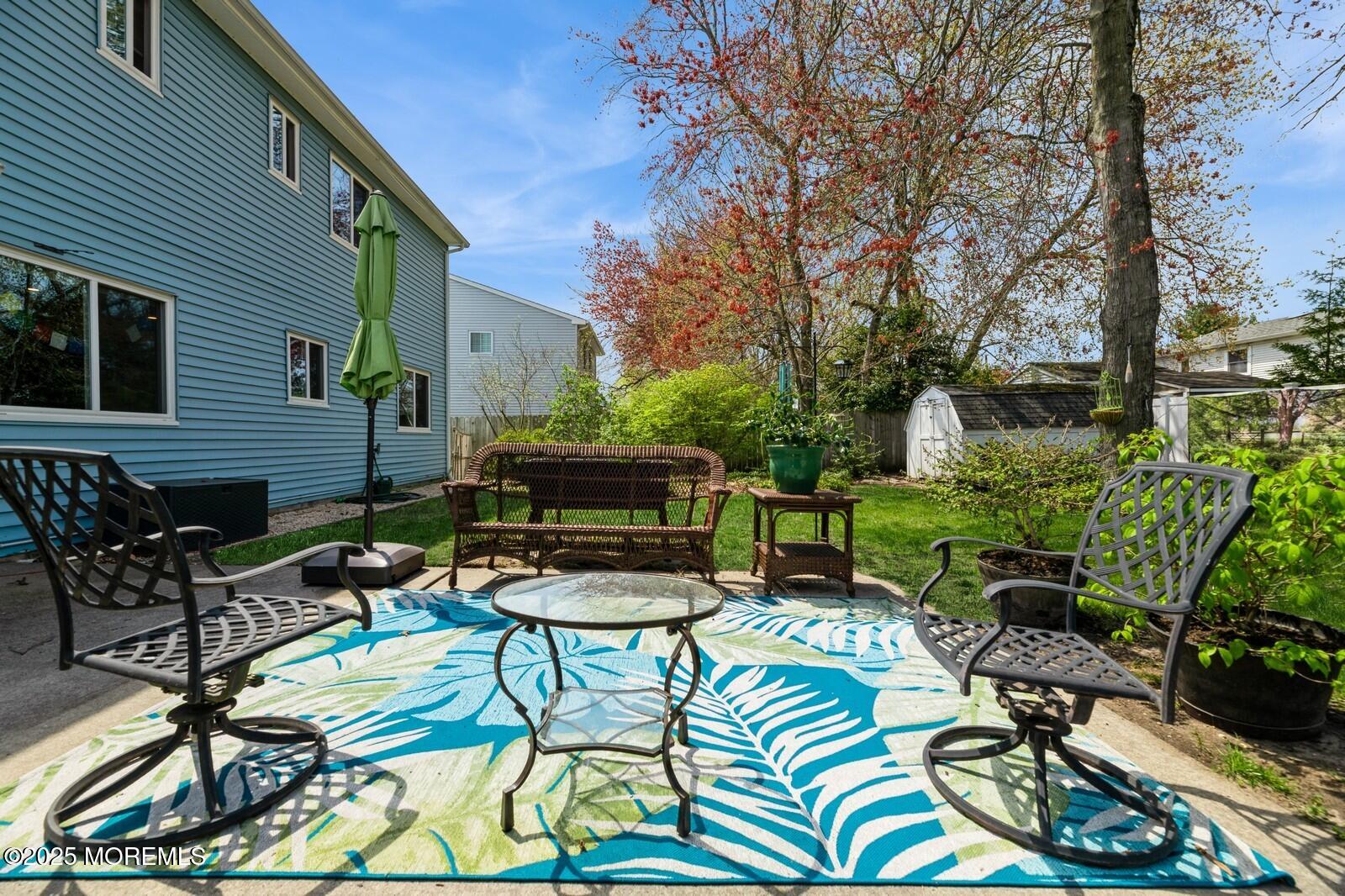 60 Appletree Road Howell, NJ 07731 - Photo 23 of 28 a view of a chairs and table in backyard of the house