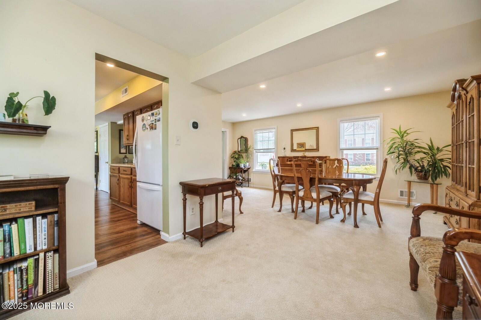 60 Appletree Road Howell, NJ 07731 - Photo 7 of 28 a living room with furniture and a dining table with bookshelf