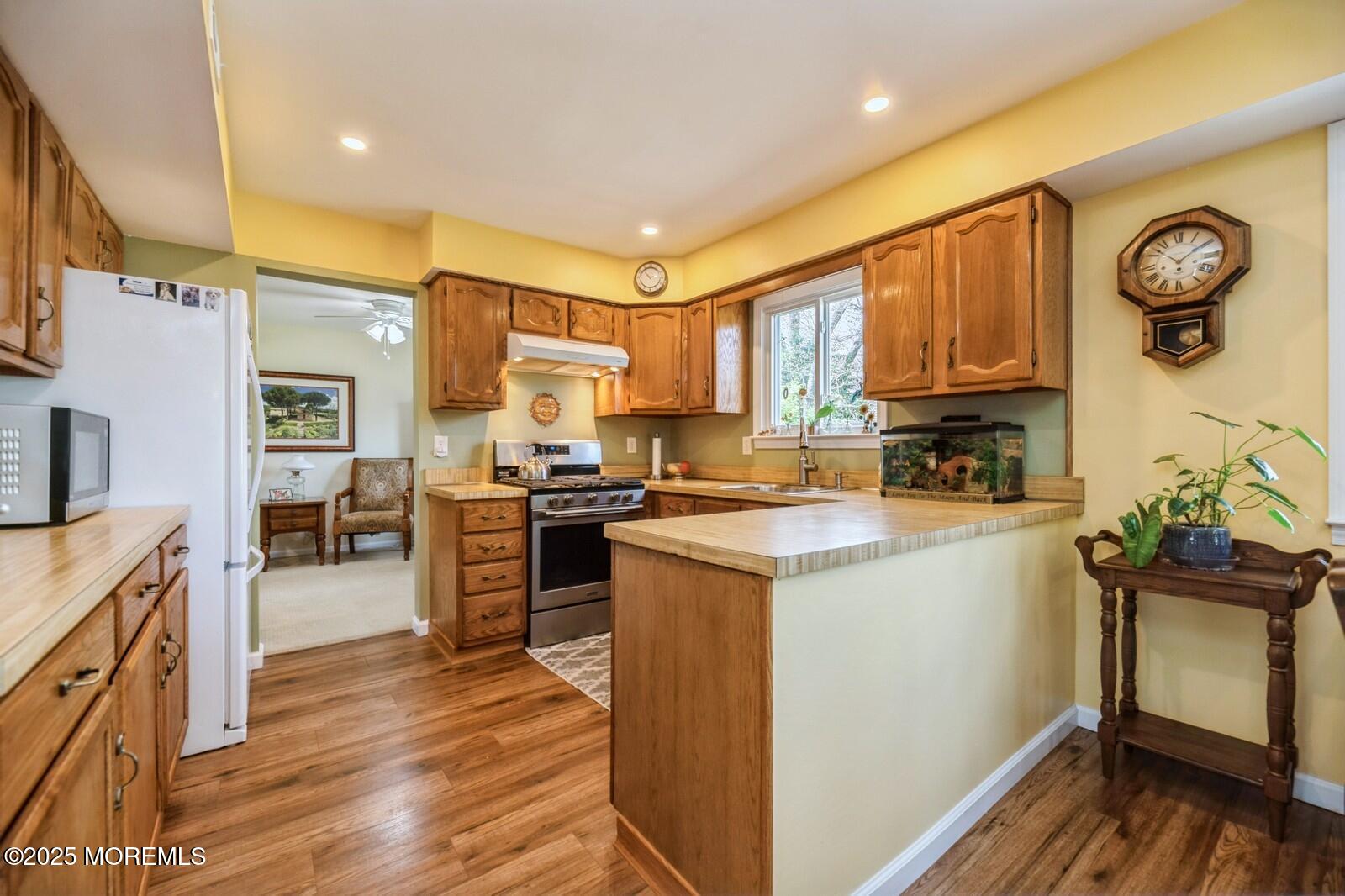 60 Appletree Road Howell, NJ 07731 - Photo 8 of 28 a kitchen with a refrigerator a stove top oven and a sink
