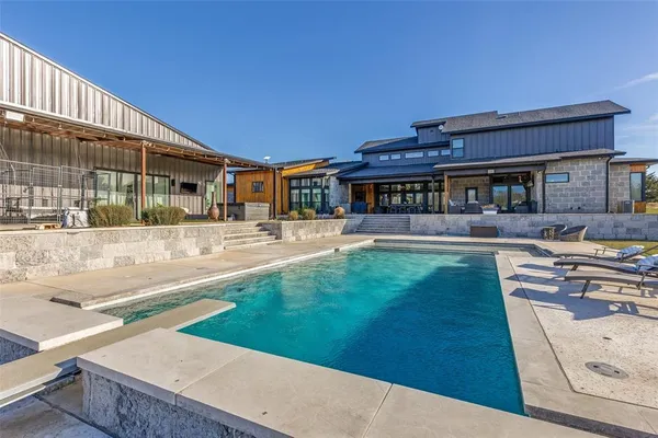 a swimming pool view with a outdoor seating