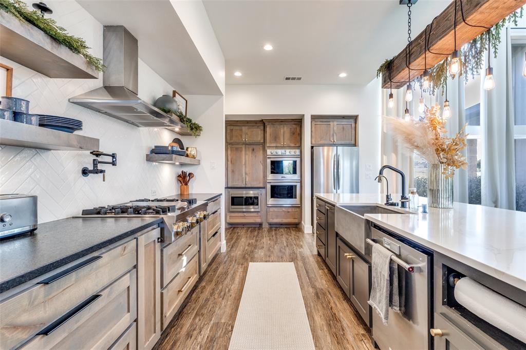 2687 North Trinity Street Decatur, TX 76234 - Photo 11 of 33 a kitchen with stainless steel appliances granite countertop a stove and a sink