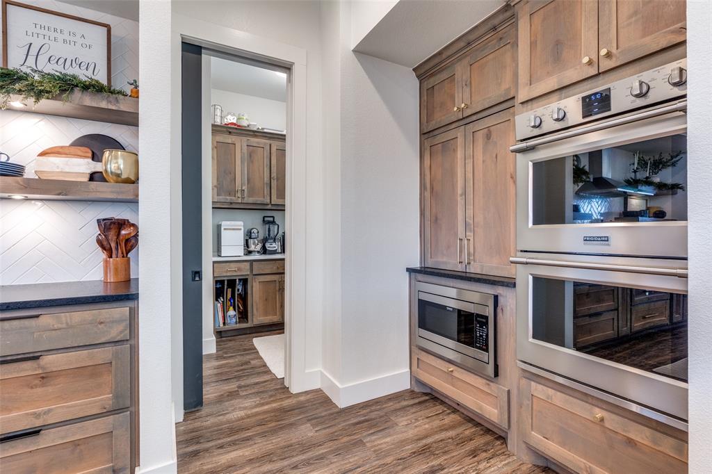 2687 North Trinity Street Decatur, TX 76234 - Photo 13 of 33 a kitchen with stainless steel appliances granite countertop a stove and a refrigerator