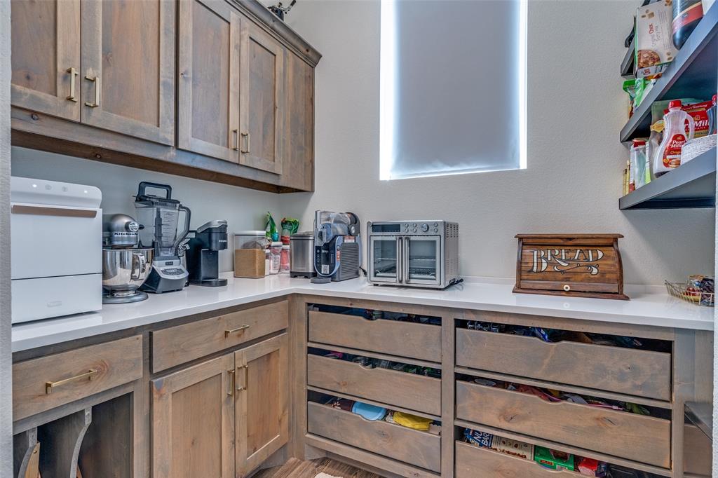 2687 North Trinity Street Decatur, TX 76234 - Photo 14 of 33 a kitchen with stainless steel appliances granite countertop a sink and cabinets