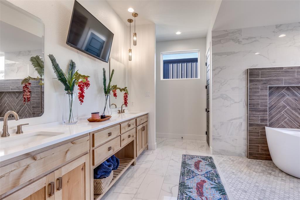 2687 North Trinity Street Decatur, TX 76234 - Photo 18 of 33 a spacious bathroom with a double vanity sink mirror and bathtub