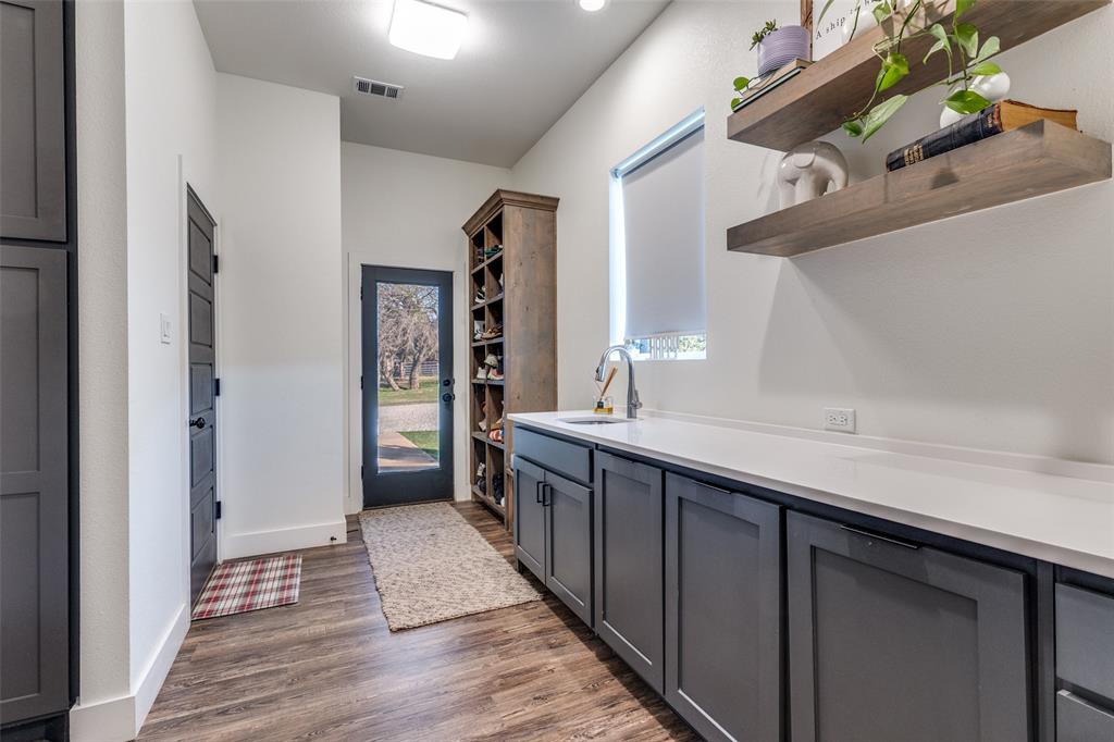 2687 North Trinity Street Decatur, TX 76234 - Photo 19 of 33 a kitchen with stainless steel appliances granite countertop a sink and cabinets