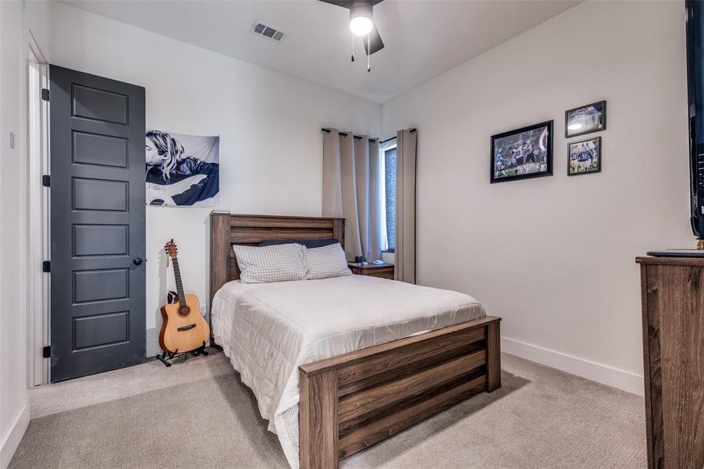 2687 North Trinity Street Decatur, TX 76234 - Photo 20 of 33 a bedroom with a bed and a chandelier