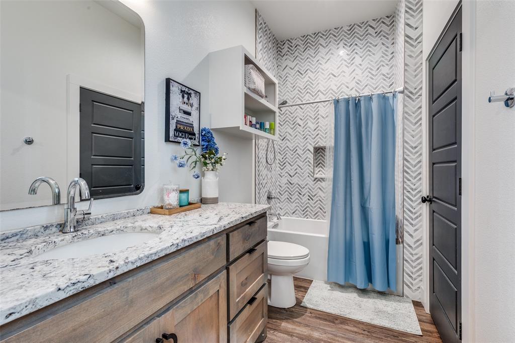 2687 North Trinity Street Decatur, TX 76234 - Photo 27 of 33 a bathroom with a granite countertop sink toilet and shower