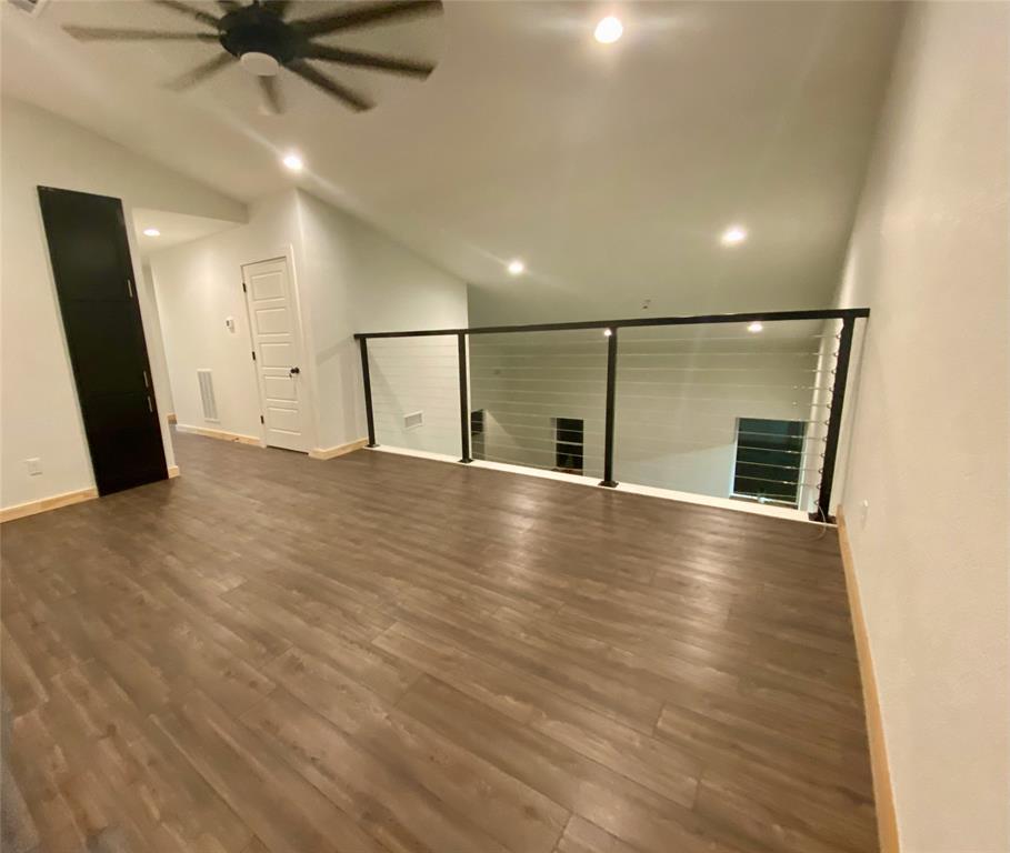 2687 North Trinity Street Decatur, TX 76234 - Photo 31 of 33 an empty room with wooden floor and a ceiling fan