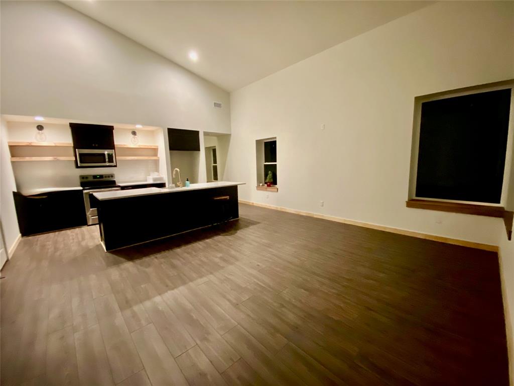 2687 North Trinity Street Decatur, TX 76234 - Photo 32 of 33 a living room with furniture flat screen tv and a fireplace