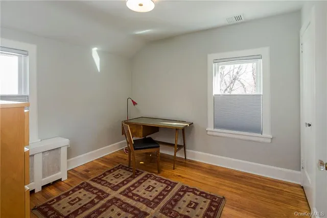 a living room with a rug and a window
