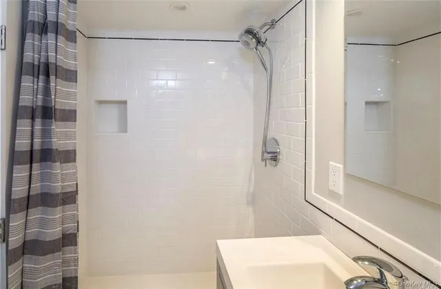 a bathroom with a shower and a vanity