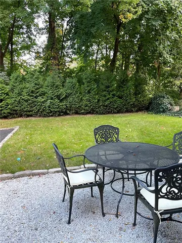 a view of a chairs and table in patio