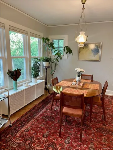 a dining room with furniture and window