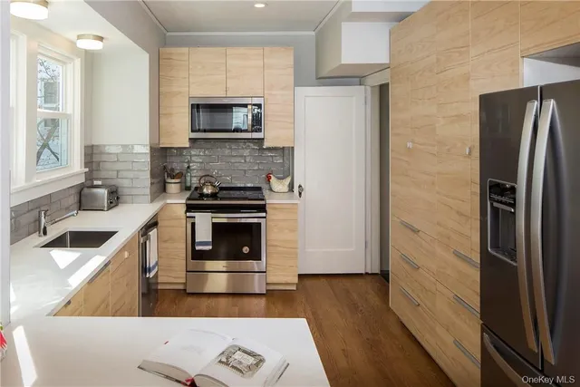 a kitchen with stainless steel appliances a stove a microwave and a refrigerator