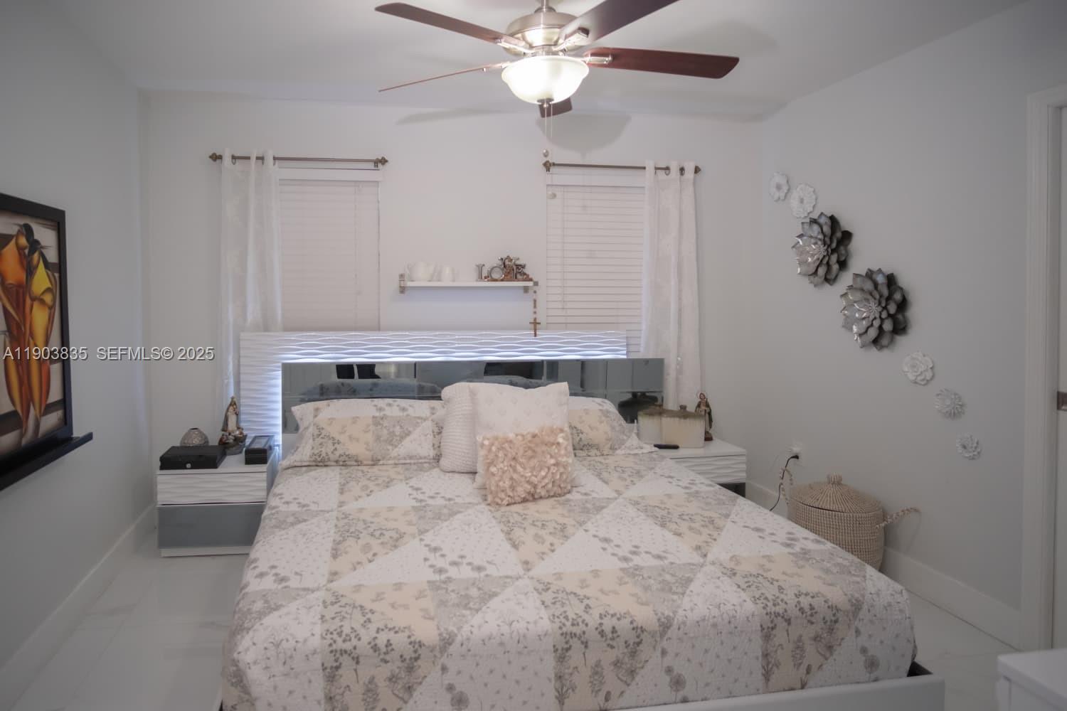 15076 Southwest 63rd Terrace Miami, FL 33193 - Photo 13 of 40 a bedroom with a large bed and a chandelier