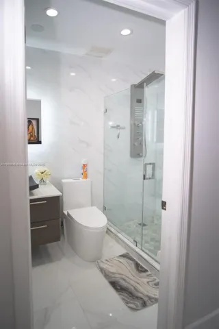 a bathroom with a sink toilet and mirror