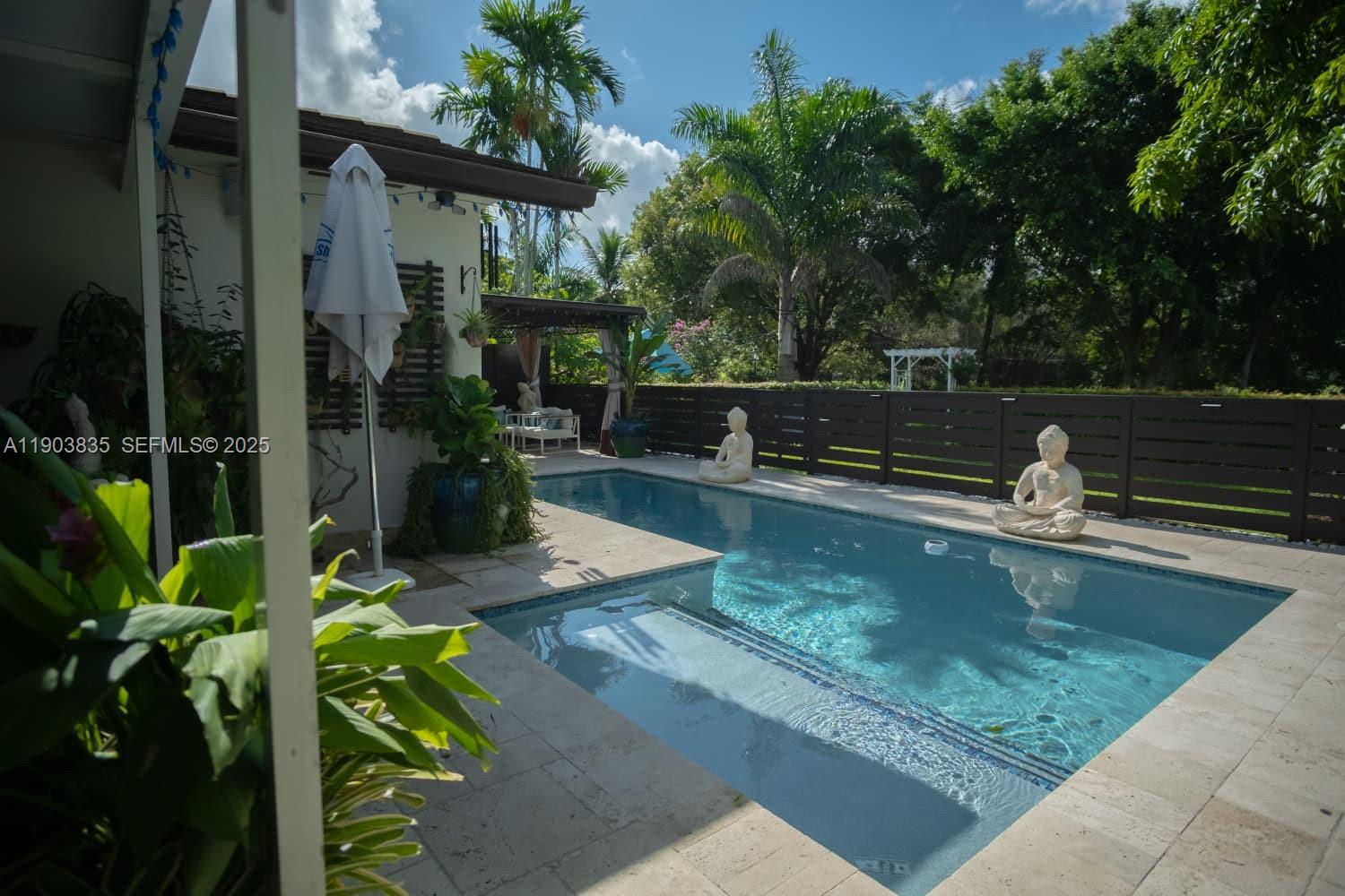 15076 Southwest 63rd Terrace Miami, FL 33193 - Photo 2 of 40 a view of a swimming pool with a patio
