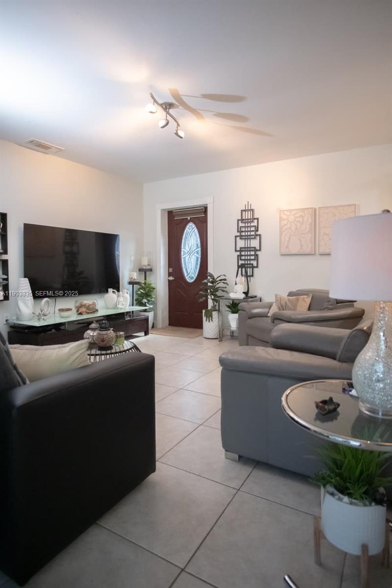 15076 Southwest 63rd Terrace Miami, FL 33193 - Photo 24 of 40 a living room with furniture and a flat screen tv