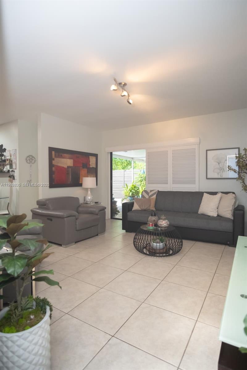 15076 Southwest 63rd Terrace Miami, FL 33193 - Photo 25 of 40 a living room with furniture and a flat screen tv