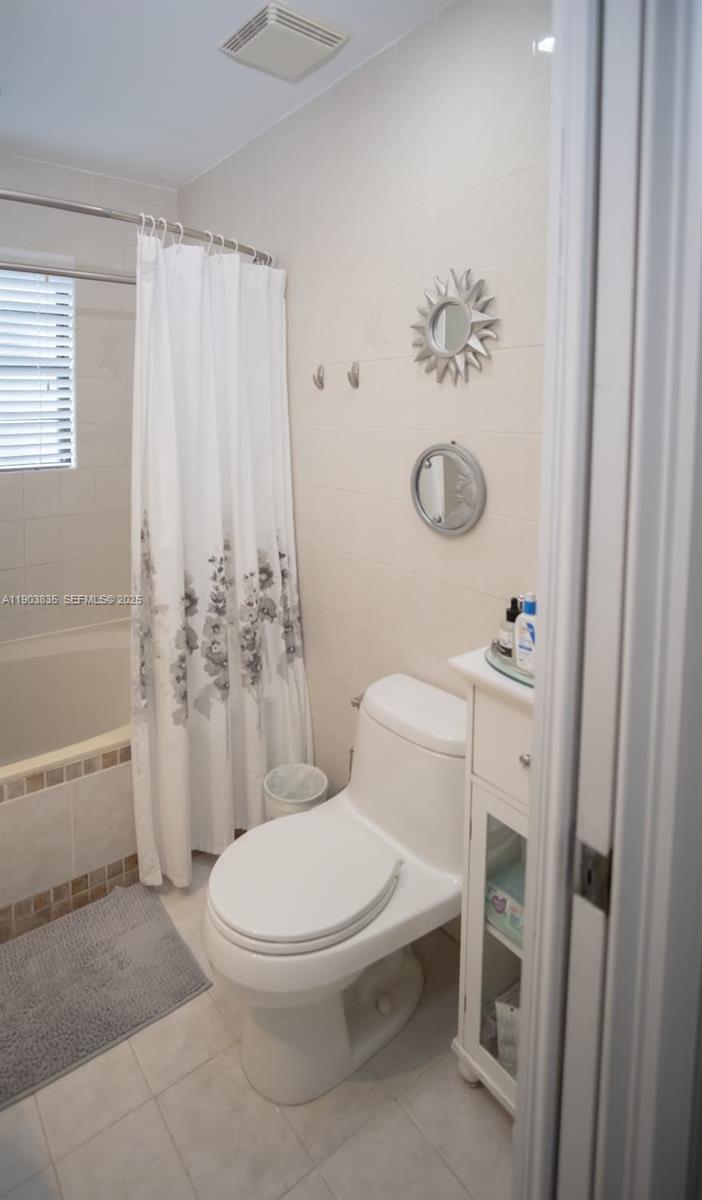 15076 Southwest 63rd Terrace Miami, FL 33193 - Photo 28 of 40 a white toilet sitting next to a bathroom sink and a tub