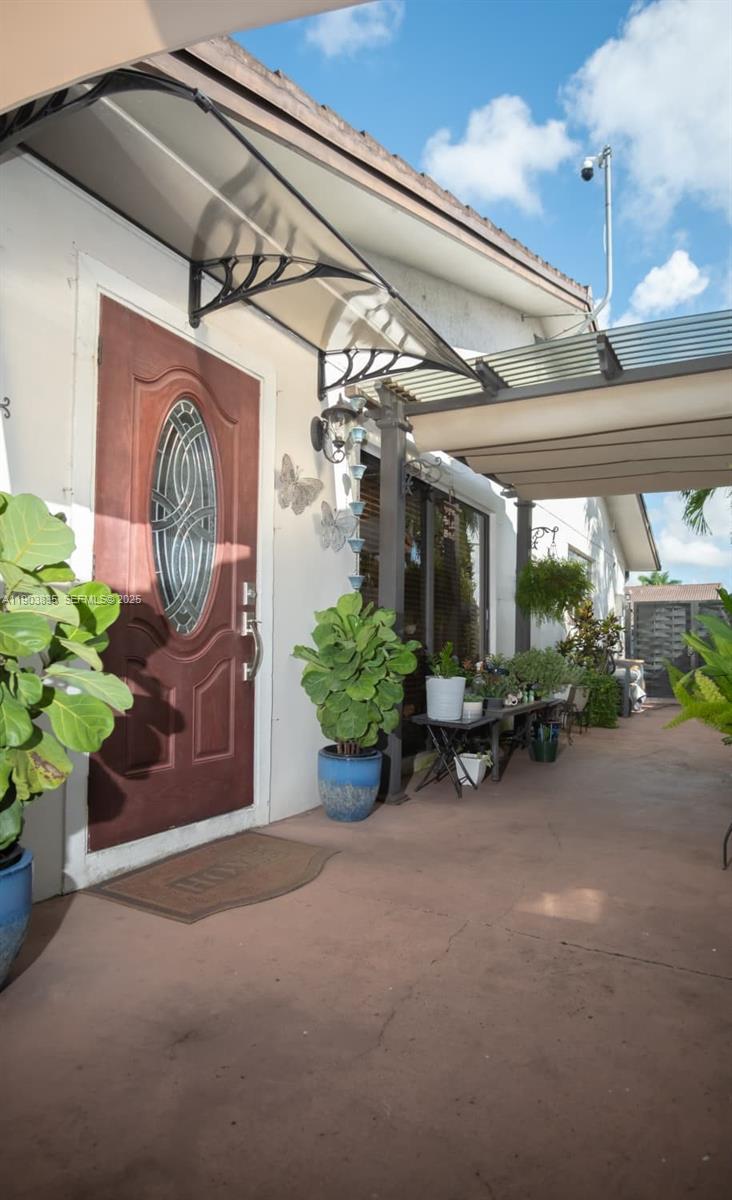 15076 Southwest 63rd Terrace Miami, FL 33193 - Photo 30 of 40 a view of a hallway with a flower pot and a potted plant