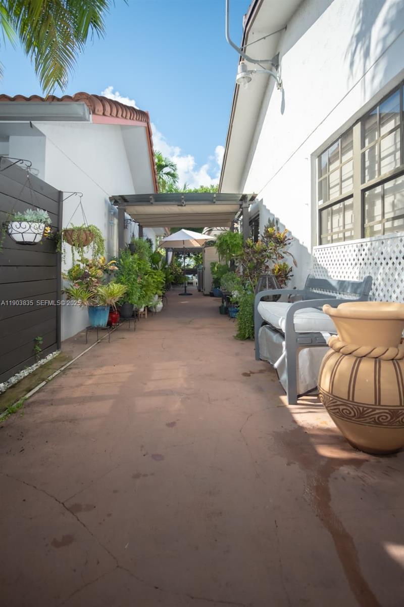 15076 Southwest 63rd Terrace Miami, FL 33193 - Photo 32 of 40 a view of a patio with potted plants and palm trees