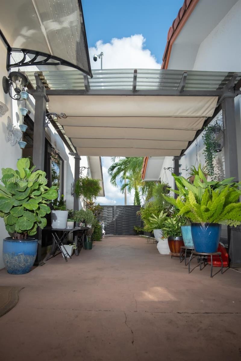 15076 Southwest 63rd Terrace Miami, FL 33193 - Photo 33 of 40 a potted plant sitting in front of a house