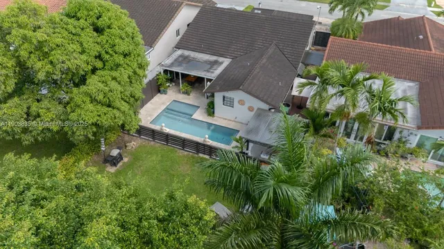 a view of backyard with swimming pool and green space