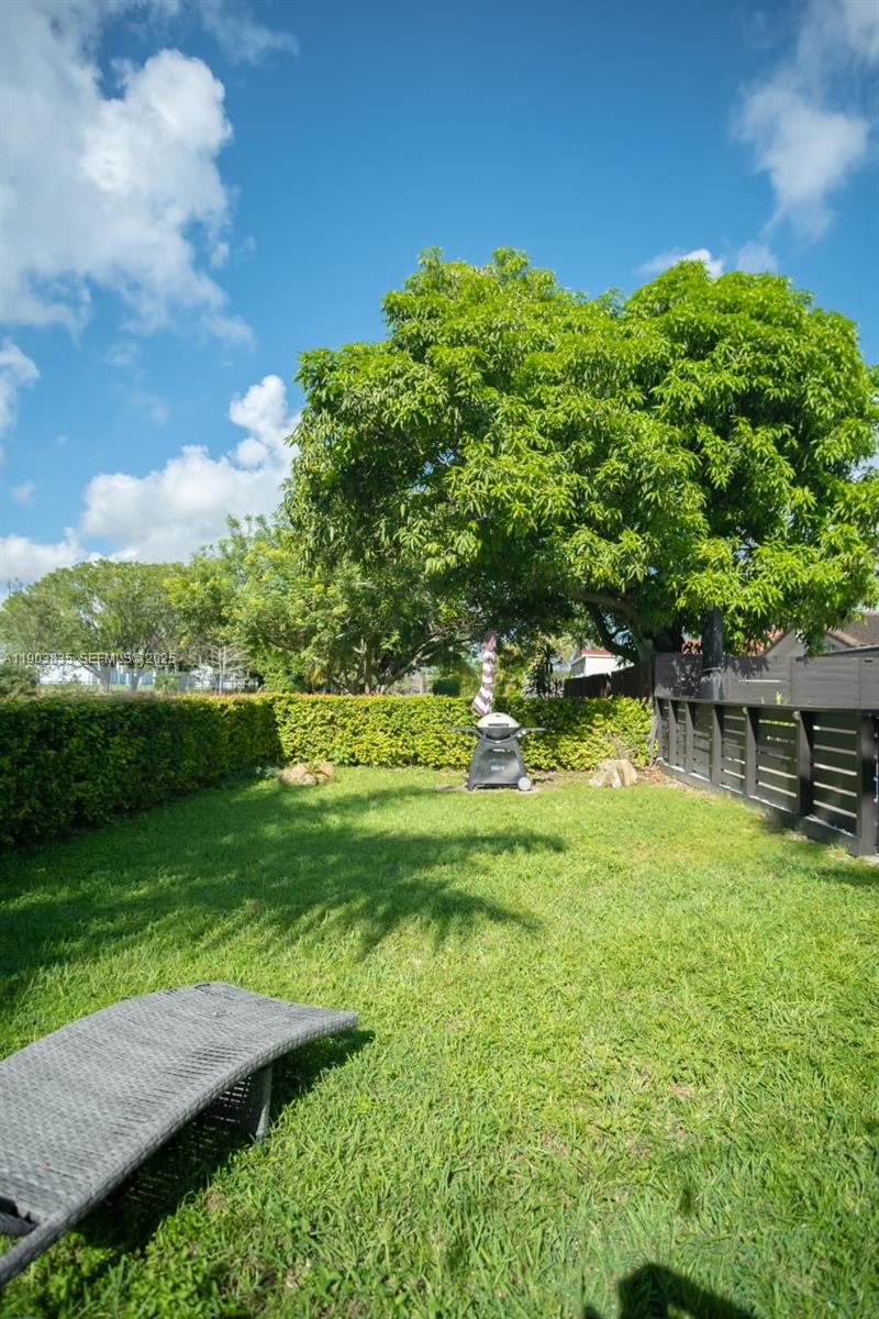 15076 Southwest 63rd Terrace Miami, FL 33193 - Photo 36 of 40 a view of backyard with swimming pool and green space