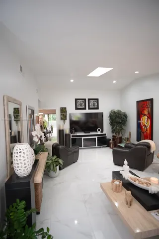 a living room with furniture and a kitchen view