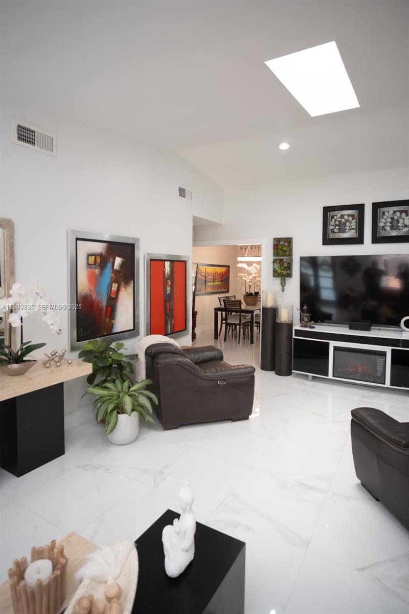 15076 Southwest 63rd Terrace Miami, FL 33193 - Photo 6 of 40 a living room with furniture and a kitchen view