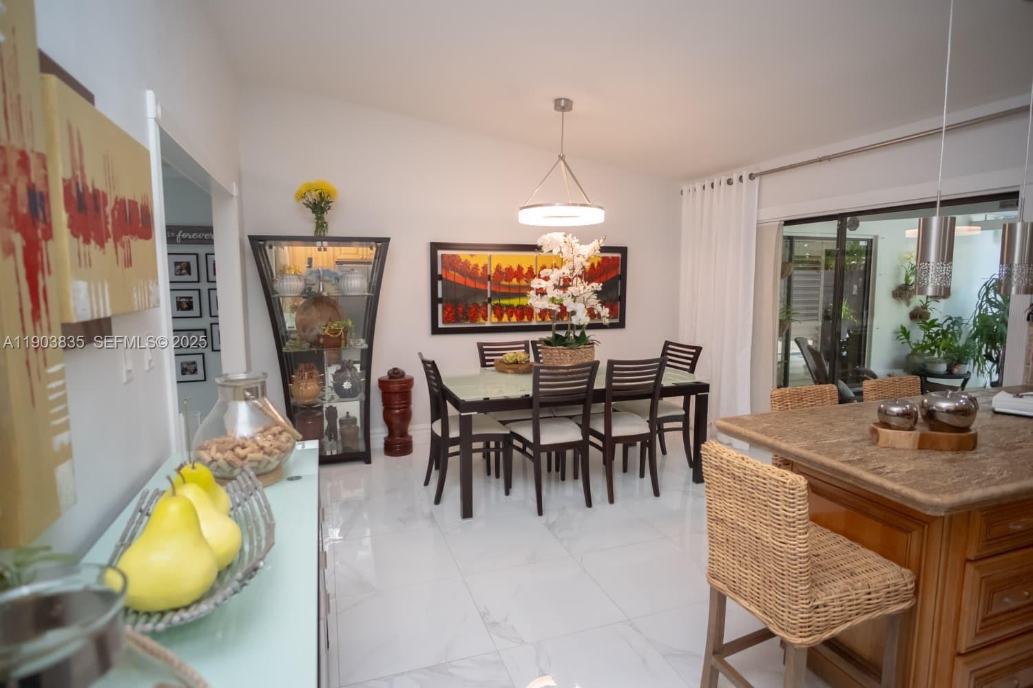 15076 Southwest 63rd Terrace Miami, FL 33193 - Photo 9 of 40 a view of a dining room with furniture and a floor to ceiling window