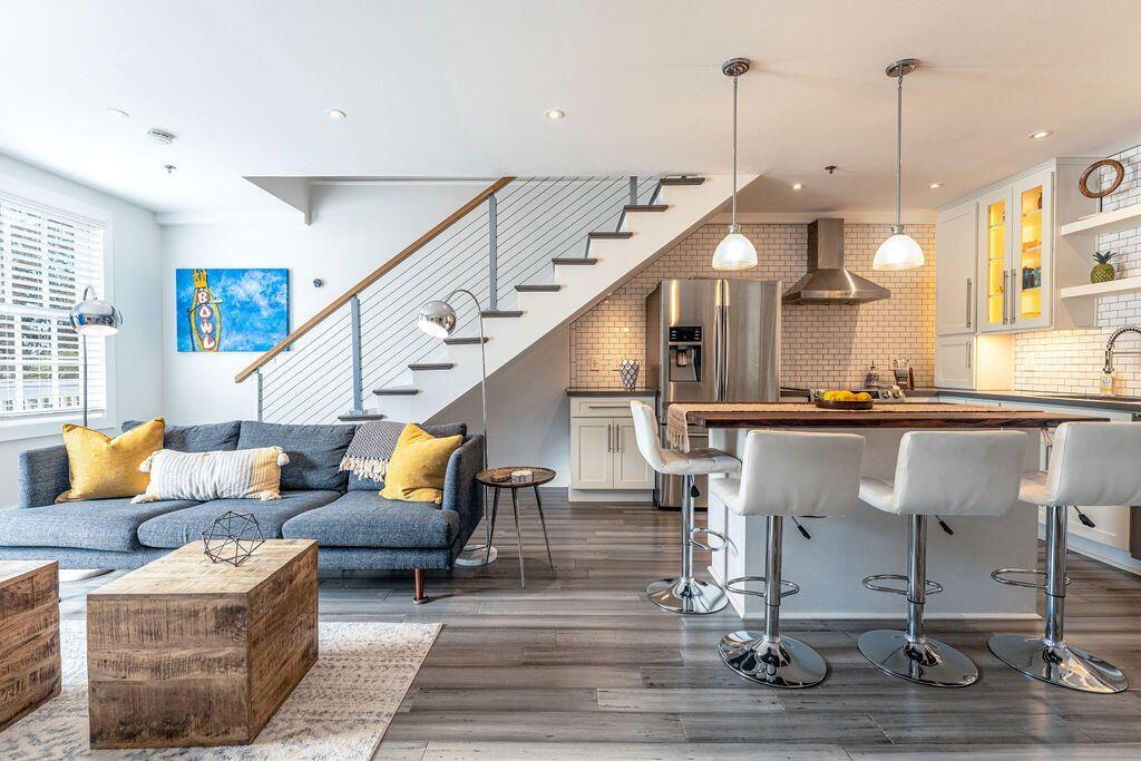 1014 Truman Avenue, Unit 3 Key West, FL 33040 - Photo 1 of 14 a living room with couches painting on the wall and a floor to ceiling window