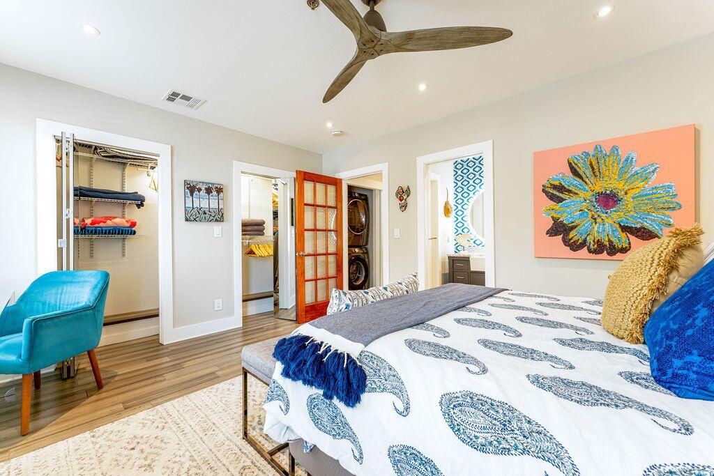 1014 Truman Avenue, Unit 3 Key West, FL 33040 - Photo 7 of 14 a spacious bedroom with a bed a dresser and a book shelf