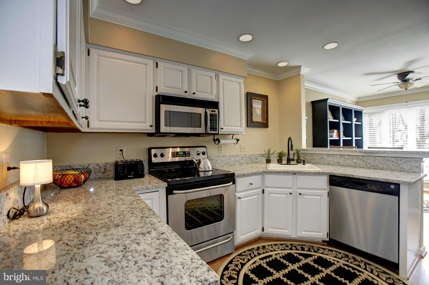 11632 Chapel Cross Way Reston, VA 20194 - Photo 14 of 30 a kitchen with stainless steel appliances granite countertop a stove a sink and a microwave